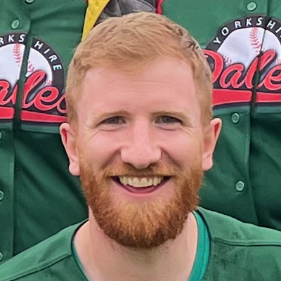 Close portrait of Dales player Tom with a ginger beard smiling in a green Dales jersey, name visible on the shirt