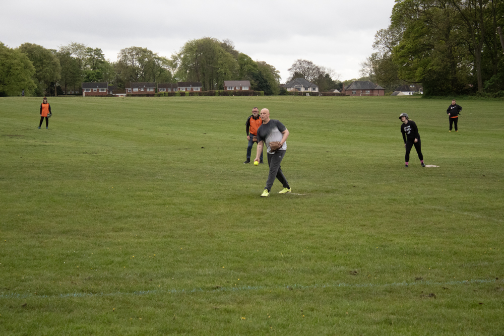 Dog On Field Coaching Drill Two players working through a coaching drill while a dog runs freely across the grass in the background
