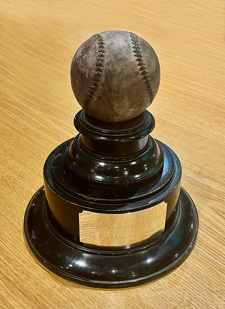 Vintage LSA trophy featuring an aged leather softball mounted on a dark wooden plinth against a plain background