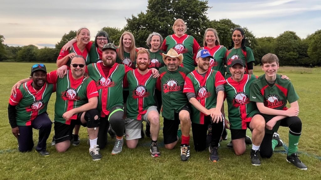 Dales league team group photo 2025, players in green and red kits in kneeling and standing rows on a grass field