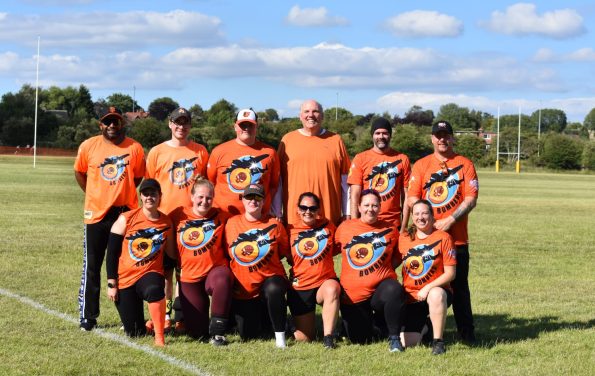 Bombers softball team in orange kit group photo