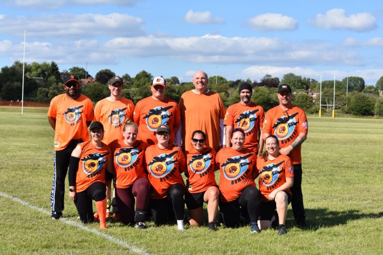Bombers softball team in orange kit, group photo at the Leeds Softball Tournament