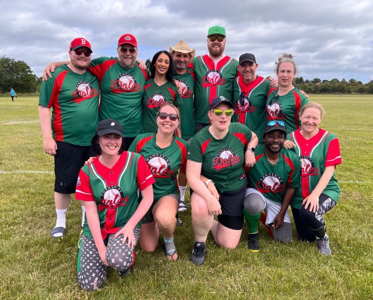 Dales team group photo in green and red kits, players in kneeling and standing rows on a grass field