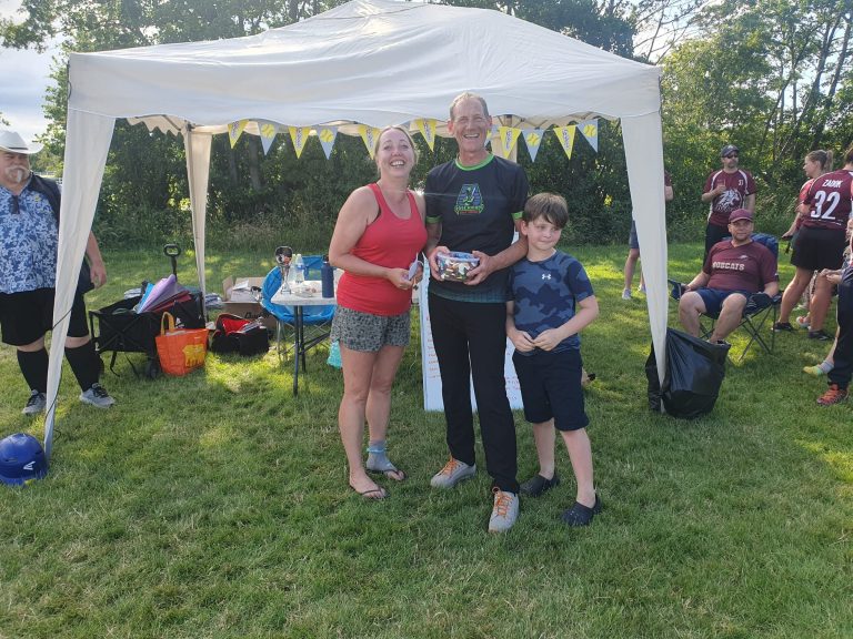 Hackers team representatives collecting runners-up prize under a marquee at the Leeds tournament ceremony