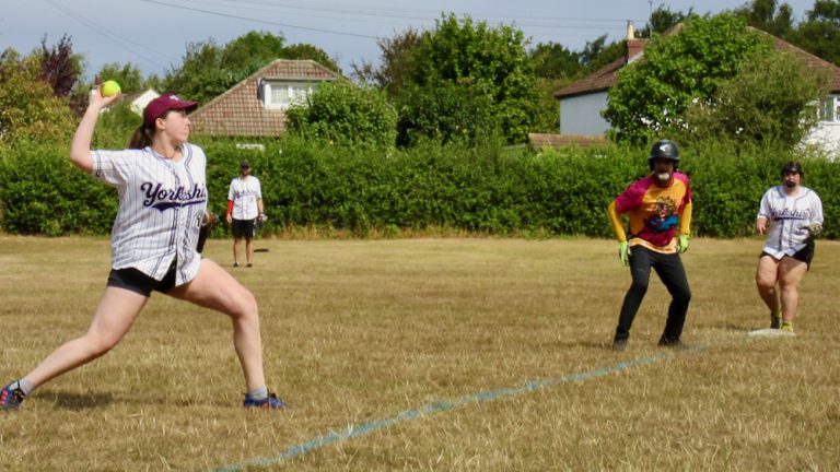 Yorkshire player throwing from third base to make the out at first, a runner in yellow kit behind